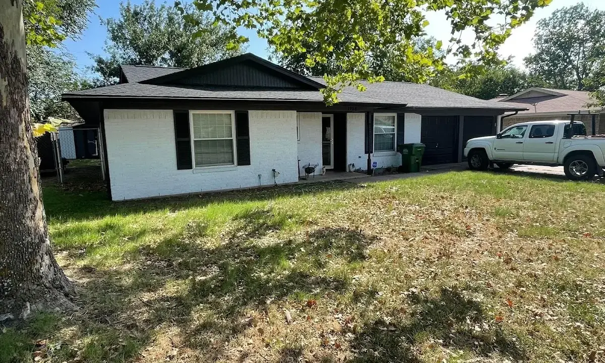 Professional roofing crew working on a residential roof in Lamesa